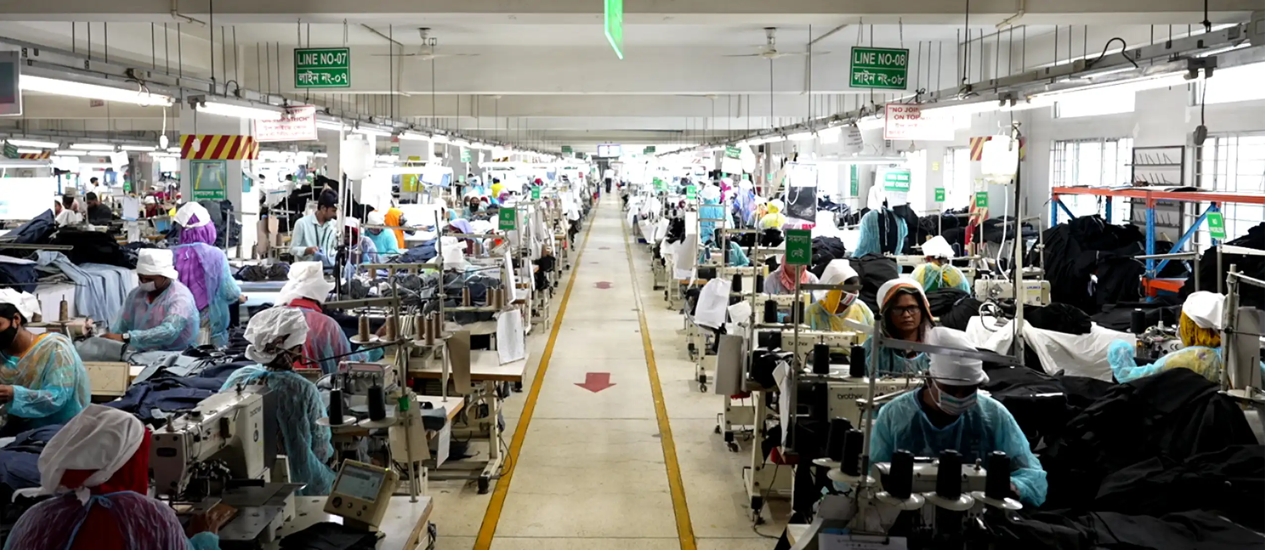 Workers working in lines on factory